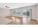 Bright living room featuring wood floors, a ceiling fan, and plenty of natural light at 2428 Hamonah Dr, Henderson, NV 89044
