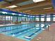 Indoor lap swimming pool with natural light and comfortable seating area at 2428 Hamonah Dr, Henderson, NV 89044