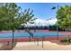 Well-maintained tennis courts with professional lighting and manicured landscaping in a lush neighborhood at 2428 Hamonah Dr, Henderson, NV 89044