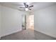 Bedroom with ceiling fan, closet, neutral carpet, and an open doorway to the hallway at 2501 Muirfield Ave, Henderson, NV 89074