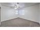 Carpeted bedroom with two windows and a ceiling fan at 2501 Muirfield Ave, Henderson, NV 89074