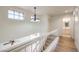 Hallway with wood-look floors, a view of the living room, and a bathroom in view at 2501 Muirfield Ave, Henderson, NV 89074