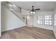 Spacious living room featuring hardwood floors, a staircase, white walls, and lots of natural light at 2501 Muirfield Ave, Henderson, NV 89074