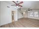 Open living room with hardwood floors, view of the staircase, access to the kitchen, and lots of light at 2501 Muirfield Ave, Henderson, NV 89074