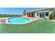 Backyard with a pool and grass, and a view of the surrounding scenery at 2997 Via Meridiana, Henderson, NV 89052
