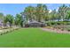 Seven Hills entrance featuring beautiful landscaping, mature trees, and decorative stone signage at 2997 Via Meridiana, Henderson, NV 89052