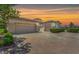 Stunning single-story home featuring multiple garages, brick driveway, and beautiful desert landscaping at 2997 Via Meridiana, Henderson, NV 89052