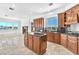 Bright kitchen boasting wood cabinetry, granite counters, a center island, and ample natural light at 2997 Via Meridiana, Henderson, NV 89052