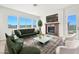 Comfortable living room with a modern fireplace, plush seating, and large windows offering scenic views at 2997 Via Meridiana, Henderson, NV 89052