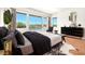 Stylish main bedroom with sliding glass doors to the backyard pool and modern furniture at 2997 Via Meridiana, Henderson, NV 89052