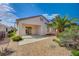 Private backyard with a covered patio, desert landscaping, and a mature palm tree at 3025 Seaford Peak Dr, Henderson, NV 89052
