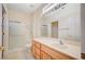 Bright bathroom features a large mirror, white countertops, and walk-in shower at 3025 Seaford Peak Dr, Henderson, NV 89052