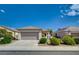 Charming single-story home with a well-manicured front yard and a two-car garage at 3025 Seaford Peak Dr, Henderson, NV 89052