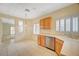 Bright kitchen features tile flooring, wooden cabinets, stainless steel appliances, and natural light at 3025 Seaford Peak Dr, Henderson, NV 89052