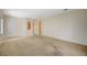 Open-concept living room with carpet flooring and natural light, ready for your personal touch at 3025 Seaford Peak Dr, Henderson, NV 89052