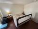 Modest bedroom with simple furnishings, featuring wood floors and ample natural light at 3150 Soft Breezes Dr # 1167, Las Vegas, NV 89128