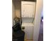 Compact laundry closet with stacked washer and dryer at 3150 Soft Breezes Dr # 1167, Las Vegas, NV 89128