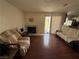 Cozy living room featuring a fireplace, hardwood floors, and sliding glass doors to outdoor space at 3150 Soft Breezes Dr # 1167, Las Vegas, NV 89128
