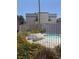 Community pool with lounge chairs, surrounded by lush landscaping and secure fencing for relaxation at 3150 Soft Breezes Dr # 1167, Las Vegas, NV 89128