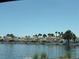Picturesque water view featuring waterfront homes with palm trees and boats, highlighting a serene environment at 3150 Soft Breezes Dr # 1167, Las Vegas, NV 89128