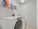 Bright laundry room featuring a Whirlpool washer and dryer and practical shelving for storage at 3420 Lockport St, Las Vegas, NV 89129
