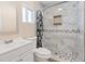 Updated bathroom features a tiled shower, modern vanity, and decorative mirror at 3715 Tabor Ave, North Las Vegas, NV 89030