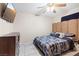 Bedroom with a patterned bedspread, tile floors, dresser, and wall mounted television at 3715 Tabor Ave, North Las Vegas, NV 89030