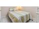 Bedroom with tile flooring and white and yellow bedspread and side table at 3715 Tabor Ave, North Las Vegas, NV 89030