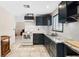 Updated kitchen with granite countertops, subway tile backsplash, black cabinets, and tile floors at 3715 Tabor Ave, North Las Vegas, NV 89030