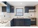 Updated kitchen features granite countertops, white appliances, black cabinets, and ample storage at 3715 Tabor Ave, North Las Vegas, NV 89030