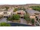 Modern home with tile roof features manicured landscaping, a three-car garage, and a paved driveway at 38 Moonfire Dr, Las Vegas, NV 89135