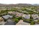 An elevated view of a luxury home, nestled in a lush landscape with distant mountain views at 38 Moonfire Dr, Las Vegas, NV 89135