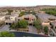 Aerial view of a beautifully landscaped home with a private driveway and a three-car garage nestled in a gated community at 38 Moonfire Dr, Las Vegas, NV 89135
