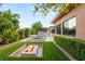 A serene backyard features a pool, spa, built-in barbecue, lush landscaping, and an inviting fire pit at 38 Moonfire Dr, Las Vegas, NV 89135