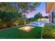 Backyard oasis with a sunken fire pit and a pristine pool and spa at 38 Moonfire Dr, Las Vegas, NV 89135