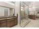 Bright bathroom showcasing glass shower, wood cabinets and countertops, and modern fixtures at 38 Moonfire Dr, Las Vegas, NV 89135