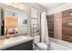 Stylish bathroom featuring a tub and shower combination with stone tiling and modern fixtures at 38 Moonfire Dr, Las Vegas, NV 89135