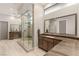 Modern bathroom featuring walk-in shower and dual vanity with lots of lighting at 38 Moonfire Dr, Las Vegas, NV 89135