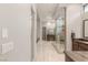 Hallway to main bath with walk-in shower, tub, vanity, and tile flooring at 38 Moonfire Dr, Las Vegas, NV 89135