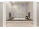 Modern bathroom with a soaking tub, stone accents and floating vanity at 38 Moonfire Dr, Las Vegas, NV 89135