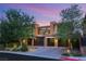 Striking home showcases modern design, desert landscaping, and driveway leading to the garage at 38 Moonfire Dr, Las Vegas, NV 89135