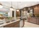 Kitchen view showcasing a large island with seating, stainless steel appliances, and stylish backsplash at 38 Moonfire Dr, Las Vegas, NV 89135