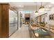Spacious kitchen with stainless steel appliances and a large island with sink, and an open concept to living spaces at 38 Moonfire Dr, Las Vegas, NV 89135