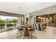 Bright kitchen, dining area and patio area with a large outdoor pool and seating area at 38 Moonfire Dr, Las Vegas, NV 89135
