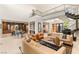 Expansive open concept living area with an eat in kitchen, bar, grand piano, and modern furnishings at 38 Moonfire Dr, Las Vegas, NV 89135