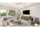 Inviting living room featuring a comfortable sectional, a large window, and contemporary decor at 38 Moonfire Dr, Las Vegas, NV 89135