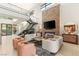 Open-concept living space featuring a fireplace, modern decor, and access to the outdoor patio at 38 Moonfire Dr, Las Vegas, NV 89135