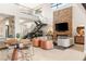 Bright living room boasting a fireplace, piano, bar area and modern staircase at 38 Moonfire Dr, Las Vegas, NV 89135