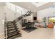 Open living area features high ceilings, fireplace, statement staircase and grand piano at 38 Moonfire Dr, Las Vegas, NV 89135