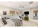 Main bedroom with fireplace, ceiling fan, and lots of natural light at 38 Moonfire Dr, Las Vegas, NV 89135